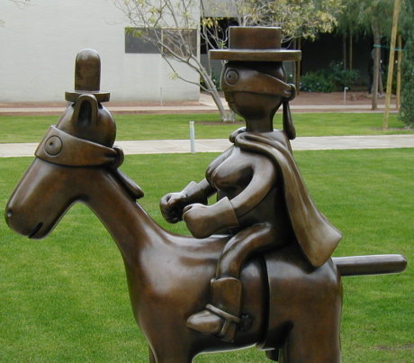 odd-looking masked figure riding on masked horse