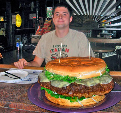 very LARGE sandwich man with giant burger