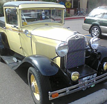 historic vehicle, eh? very old Ford car in parking lot