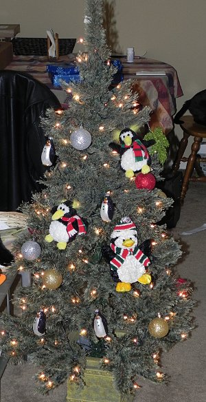 tree full of penguins, eh? Christmas tree with a bunch of penguin ornaments hanging from it
