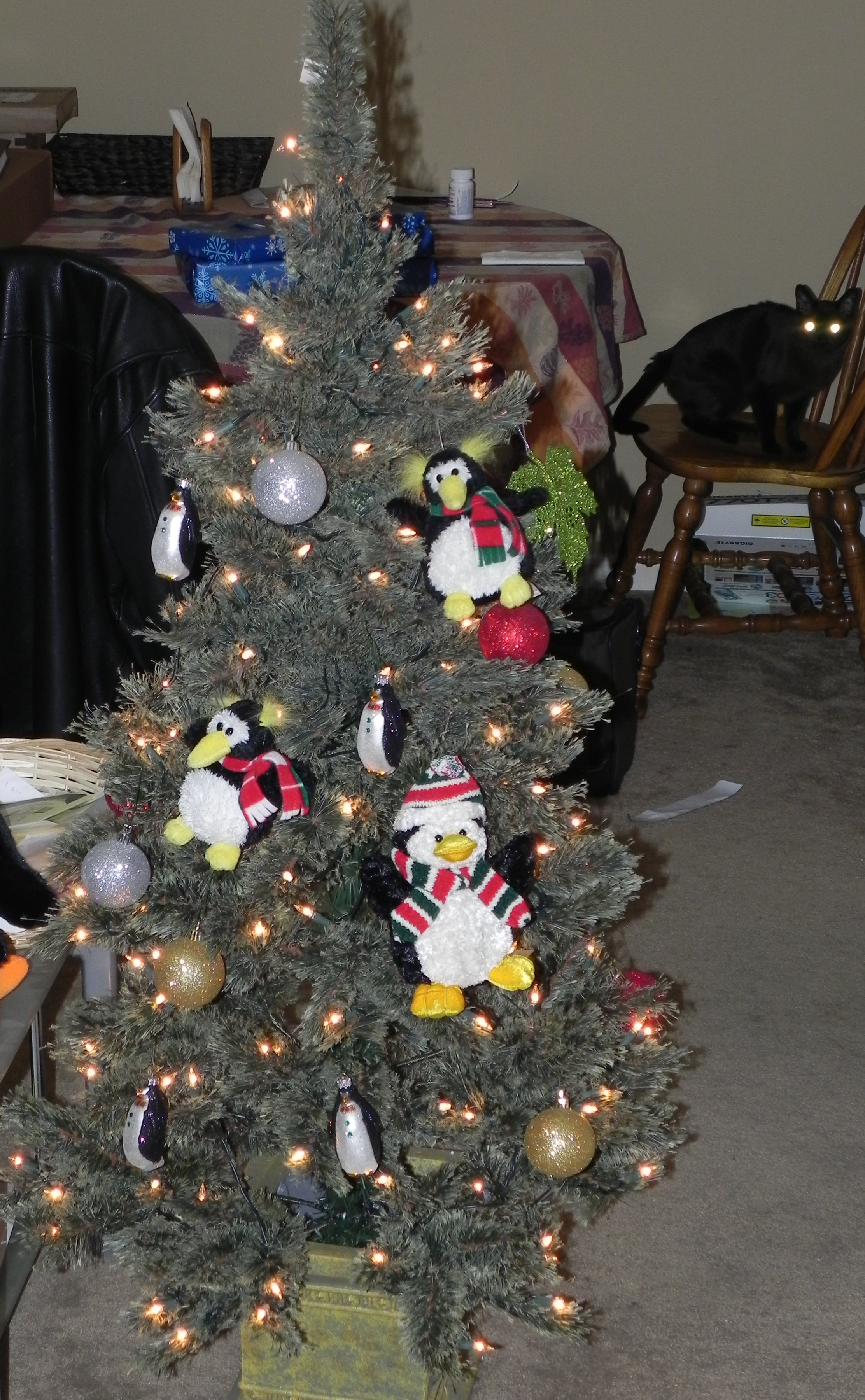 tree full of penguins, eh? Christmas tree with a bunch of penguin ornaments hanging from it