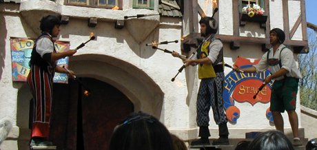 only trained professionals should wear fire on their heads the London Broil doing team juggling with flaming torches