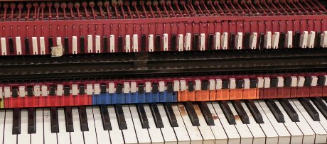 marker piano used for creating player piano rolls, with a coffee stain on some of the keys