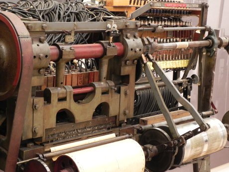 very old electrically-driven assembly of belts, gears, and stuff for creating player piano rolls.  This looked like an OSHA incident waiting to happen.