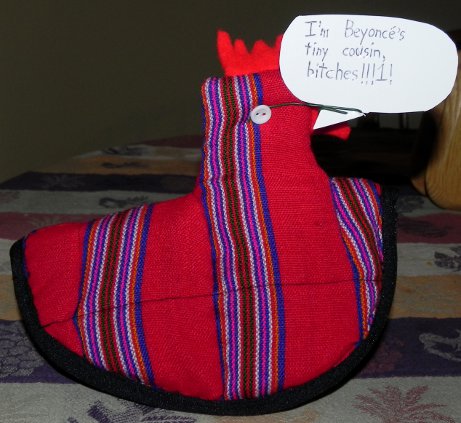 decorative chicken potholder saying 'I'm Beyonce's tiny cousin, bitches!!1!'
