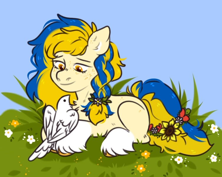 Ukraine pony lying down with dove perched on feet