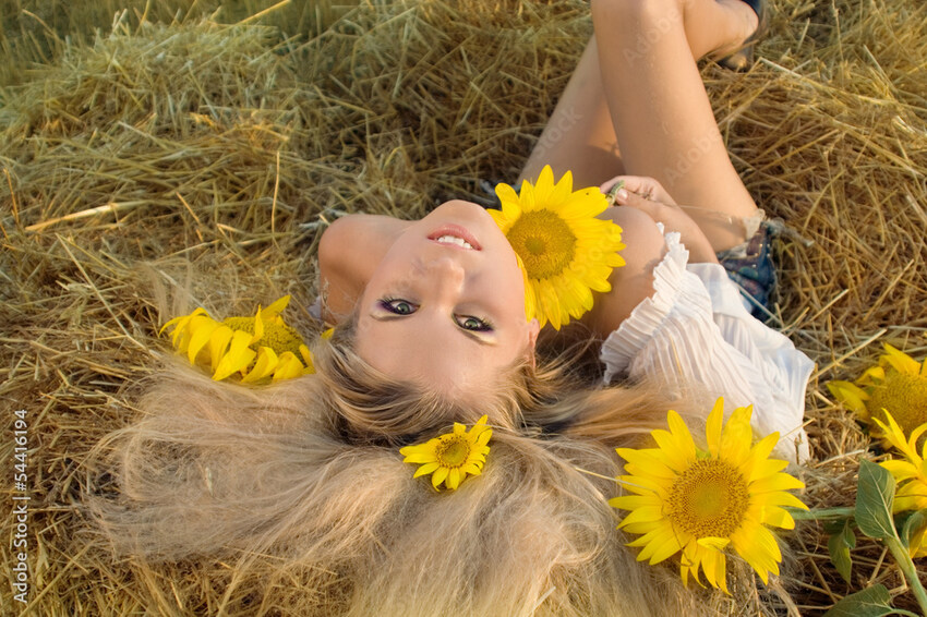 Cute blonde with sunflowers.